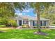 Charming home with manicured lawn, blue shutters, and brick accents creating a welcoming exterior at 2782 Cedar Knoll Dr, Apopka, FL 32712