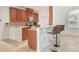 Cozy kitchen with granite countertops and a breakfast bar that opens to a carpeted living area at 2782 Cedar Knoll Dr, Apopka, FL 32712