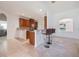 Open kitchen featuring granite counters, dark wood cabinetry, mosaic backsplash, and breakfast bar with seating at 2782 Cedar Knoll Dr, Apopka, FL 32712