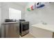 Laundry room with stainless steel washer and dryer, sink, and storage at 2782 Cedar Knoll Dr, Apopka, FL 32712