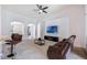 A cozy living room with modern ceiling fan, plush sofa, and TV set against a white wall at 2782 Cedar Knoll Dr, Apopka, FL 32712