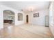Spacious living area with neutral carpet, arched entryways, and access to the kitchen at 2782 Cedar Knoll Dr, Apopka, FL 32712