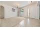 Well-lit living room area featuring neutral carpet, tiled entry, and a bright window for natural light at 2782 Cedar Knoll Dr, Apopka, FL 32712