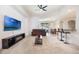 Bright living room with a vaulted ceiling, bar seating, and an entertainment center at 2782 Cedar Knoll Dr, Apopka, FL 32712
