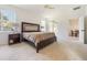 Spacious main bedroom featuring a large bed, side tables, and an open doorway to the dining area at 2782 Cedar Knoll Dr, Apopka, FL 32712