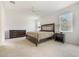 Bright bedroom featuring a large bed, dresser, and nightstand; natural light shines in from a window at 2782 Cedar Knoll Dr, Apopka, FL 32712