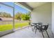 Screened patio with a table and chairs overlooking the backyard at 2782 Cedar Knoll Dr, Apopka, FL 32712
