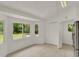 Bright kitchen area featuring tile flooring, natural light, and access to backyard views through multiple windows at 295 Maguire St, Deltona, FL 32725