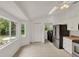 Bright kitchen with stainless steel appliances, tiled floor, and an adjacent laundry area, offering modern convenience at 295 Maguire St, Deltona, FL 32725