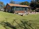 Backyard featuring an enclosed sunroom and green lawn at 3021 Norvell Ct, Deltona, FL 32738