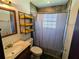 Cozy bathroom featuring a shower with a gray curtain and dark tile floor at 3021 Norvell Ct, Deltona, FL 32738