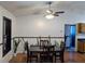 The dining room has a wooden table, chairs and hardwood floors with a view into the kitchen at 3021 Norvell Ct, Deltona, FL 32738