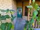 Close-up of a teal front door with a wreath and lush greenery framing the entrance to the home at 3021 Norvell Ct, Deltona, FL 32738