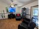 This open living area has comfortable leather seating, a piano, and a door leading to the patio at 3021 Norvell Ct, Deltona, FL 32738