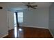 The bedroom has wood floors and a ceiling fan at 3024 S Semoran Blvd # 7, Orlando, FL 32822