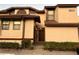 Beige two-story home with a well-manicured lawn and front door at 3024 S Semoran Blvd # 7, Orlando, FL 32822