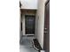 A close up of the front door with decorative trim and an adjacent brown door on a stucco exterior at 3024 S Semoran Blvd # 7, Orlando, FL 32822