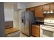 The kitchen features wood cabinets, stainless steel appliances, and a granite counter at 3024 S Semoran Blvd # 7, Orlando, FL 32822