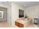 Bathroom featuring a soaking tub with marble surround, artwork, and travertine floors at 3426 Cocard Ct, Windermere, FL 34786