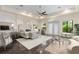 Primary bedroom with neutral tones, tray ceilings, and a seating area near large windows with backyard views at 3426 Cocard Ct, Windermere, FL 34786