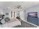 Bright bedroom featuring a ceiling fan, soft rug, and a light blue dresser with a TV at 3426 Cocard Ct, Windermere, FL 34786
