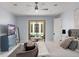 Comfortable bedroom showcasing a ceiling fan, TV, and outside access to a tranquil outdoor area at 3426 Cocard Ct, Windermere, FL 34786