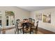 Charming dining room with dark wood table and whimsical art at 3426 Cocard Ct, Windermere, FL 34786