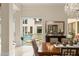 Dining room with elegant chandelier, view of the pool area, and formal table setting at 3426 Cocard Ct, Windermere, FL 34786