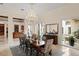An elegant dining room with a chandelier, an elaborate table setting, and views of the pool and backyard at 3426 Cocard Ct, Windermere, FL 34786