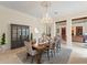 Elegant dining room with a chandelier, large dining table, and a built-in china cabinet at 3426 Cocard Ct, Windermere, FL 34786