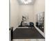 Exercise room with an elliptical machine, dumbbells, mirrored wall and rubber flooring at 3426 Cocard Ct, Windermere, FL 34786