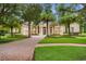 Elegant home with a long brick driveway, lush lawn, and well-maintained landscaping with mature trees at 3426 Cocard Ct, Windermere, FL 34786