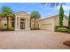Stately home featuring a tile roof, paver driveway, two-car garage, and manicured landscaping at 3426 Cocard Ct, Windermere, FL 34786