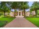 Elegant home featuring a brick driveway, manicured lawn, and tropical landscaping at 3426 Cocard Ct, Windermere, FL 34786