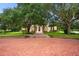 Attractive home with lush green lawn and a long brick driveway leading to the columned front entrance at 3426 Cocard Ct, Windermere, FL 34786