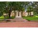 Beautiful home with mature trees, landscaping, and a brick paver driveway leading to the entrance at 3426 Cocard Ct, Windermere, FL 34786