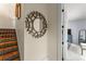 Hallway with colorful tile stairs, decorative mirror, and access to a bedroom at 3426 Cocard Ct, Windermere, FL 34786