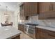 Gourmet kitchen with custom cabinets and countertops, stainless steel appliances, and a large island cooktop at 3426 Cocard Ct, Windermere, FL 34786