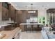 Gourmet kitchen boasts custom cabinetry, stainless steel appliances, and a large center island with seating at 3426 Cocard Ct, Windermere, FL 34786