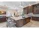 Open kitchen with a center island, custom cabinets, and seamless flow to the dining and living areas at 3426 Cocard Ct, Windermere, FL 34786