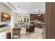 Open-concept living room with a modern fireplace, natural light, and seamless connection to the kitchen at 3426 Cocard Ct, Windermere, FL 34786