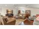 Comfortable living room with hardwood floors, three sofas, and a TV at 3426 Cocard Ct, Windermere, FL 34786