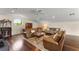Spacious living room with hardwood floors, three sofas, and unique round window at 3426 Cocard Ct, Windermere, FL 34786