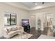 Bright living room featuring a curved couch, elegant decor, and a large window overlooking the pool at 3426 Cocard Ct, Windermere, FL 34786