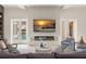 Cozy living room with fireplace and pool view, showcasing comfortable seating and elegant decor at 3426 Cocard Ct, Windermere, FL 34786