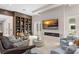 Stylish living room with built-in shelves, a modern fireplace, and access to outdoor amenities at 3426 Cocard Ct, Windermere, FL 34786