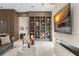 Cozy living room featuring custom built-in shelving, a modern fireplace, and neutral decor at 3426 Cocard Ct, Windermere, FL 34786
