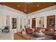 Expansive living room with wood ceiling accents, a fireplace, and multiple seating areas at 3426 Cocard Ct, Windermere, FL 34786