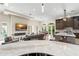 Expansive space features an open living, kitchen, and dining layout with seamless access to an outdoor pool area at 3426 Cocard Ct, Windermere, FL 34786