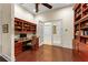 Home office with custom built-in shelving, hardwood floors, and French doors leading to another room at 3426 Cocard Ct, Windermere, FL 34786